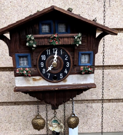 Fun wall clock has a lady on a spring for a pendulum. Cabinet in good condition and measures about