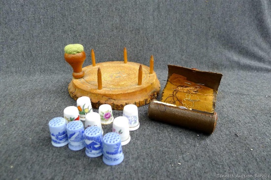 Neat yarn holder with porcelain thimbles and a small sewing kit. Yarn holder measures 6'' dia.