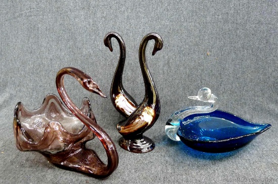 Pretty glass art swans, makes for unique bookshelf decorations or candy holders. Tallest measures