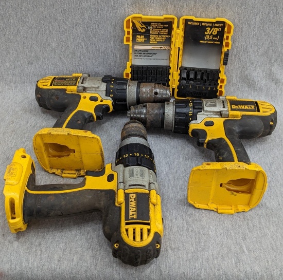 Three DeWalt 18 volt VSR drills and a DeWalt drill bit case. Drills are