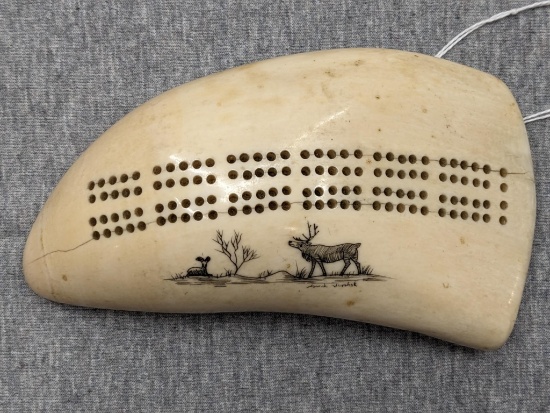 Scrimshaw whale tooth ivory cribbage board by Alaskan Native artist Howard Sikvoan Weyahok (1911 -