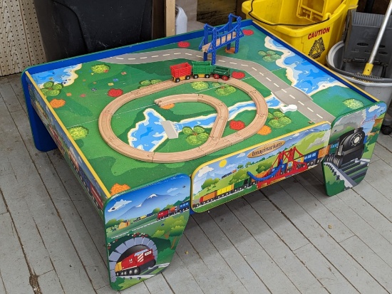 Imaginarium children's train table is about 44" x 33" x 16" high. Has drawer to store extra parts.