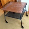 Rolling TV cart has been adapted to be an end table or coffee table, footprint is approx. 2' x 2'.