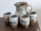 Charming stoneware pitcher and glasses are in good condition and measure about 4-1/2