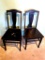 Two sturdy wooden chairs stand 38
