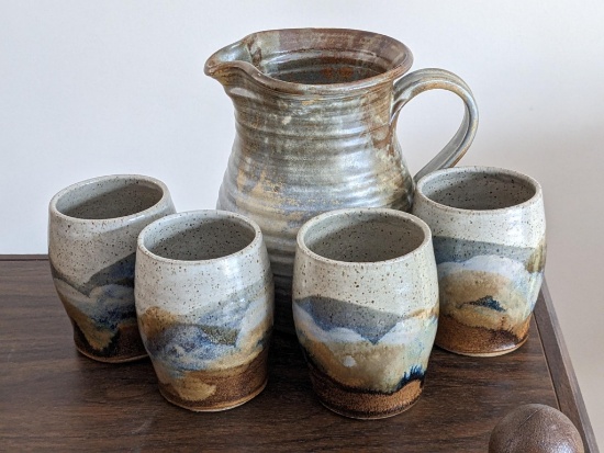 Charming stoneware pitcher and glasses are in good condition and measure about 4-1/2" and 8" tall.