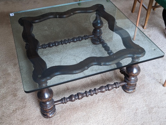 Square coffee table with the retro chunky wooden legs and glass top; measures 40" x 17" tall. Glass