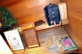 Contents of master bathroom and sauna room including towels, wastebasket, luggage, artificial
