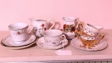 Tea cups, saucers, creamer & sugar, etc. Some pieces marked Germany.