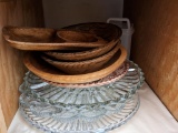 Two shelves including appetizer trays, colander, sifter and more.