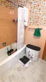 Contents of bathroom including scale, towels, wash cloths, wicker hamper, plungers, toilet brushes,