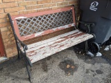 Charming garden bench with cast iron ends and lattice is over 4' wide.