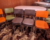 Totally retro Formica topped table with classic green, orange and brown upholstered chairs. Table is