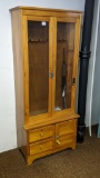 Custom made hardwood gun cabinet with unique swinging / sliding door. Measures 30
