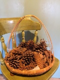 Basket of pine cones. Largest measures approx 6