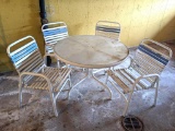 Glass top patio table and four matching chairs. The table is in good condition with a little pain