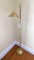 Adjustable height gold toned floor lamp is in good condition. Works and raises to 62