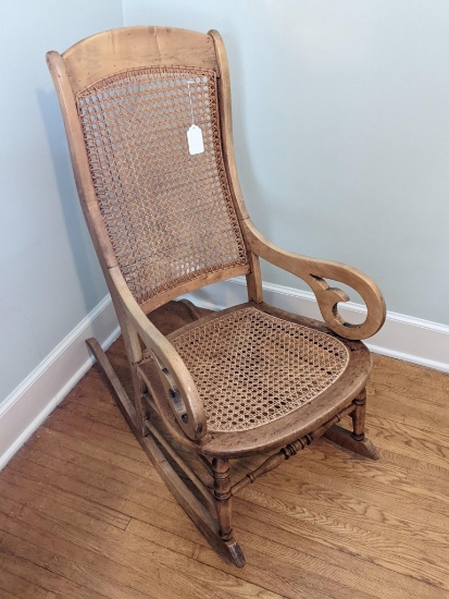 Antique birds-eye maple rocking chair with caned back and seat is in great condition and measures