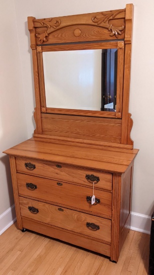 Beautiful antique dresser with dovetailed drawers, mirror, and attractive trim. Base measures about