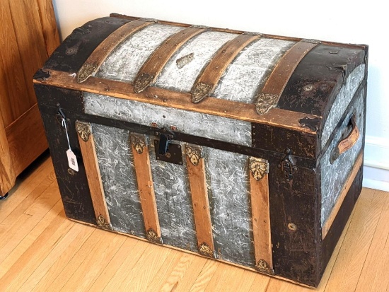 Antique steamer trunk is in good condition. Still retains leather handles, and has attractive