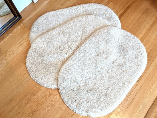 Set of three cream colored rugs by Regal measure 26" x 40". In nice condition. Come from a smoke