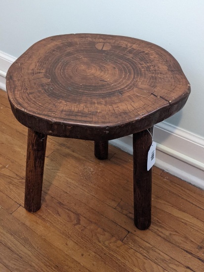 Charming 3-legged stool is in good condition and about 15" wide and 17" tall.