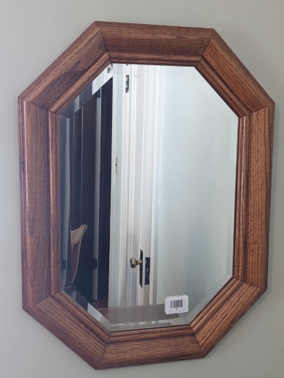 Beveled glass mirror with pretty wood frame is 18" x 24" and in good condition. Can be hung vertical