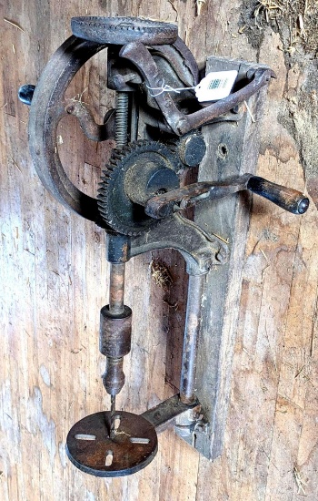 Upstairs, bring help. Antique blacksmith's hand crank post drill with automatic feed. Gears turn