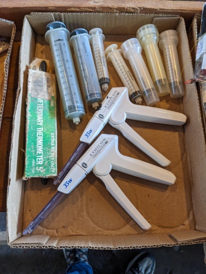 Two veterinary staplers by Ethicon Proximate, plus vet thermometers and syringes.