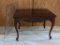 Antique table with book matched walnut burl veneer top and high relief carving is in good condition.