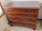Classic looking four drawer dresser by Reid Classics Furniture has dovetailed drawers, glass top and