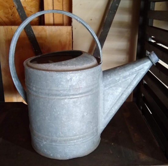 Galvanized watering can stands 14" tall and is marked no.8.
