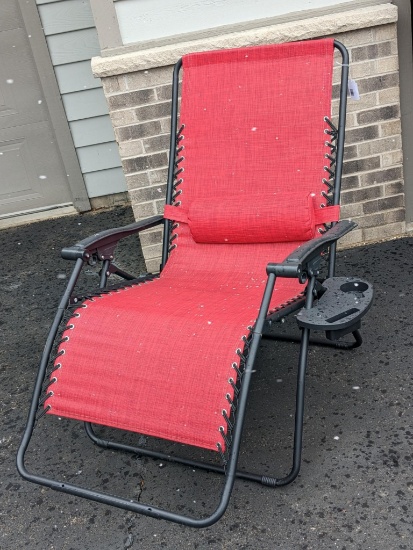Folding campfire or patio chair with adjustable footrest. The chair appears to be in near new