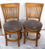 Set of 2 swiveling chairs sold by Hung Fung Woods Co.; each measures 19
