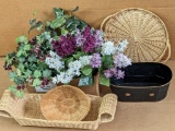 Faux lilacs, ivy and more, wicker trays and baskets, plus a metal planter.