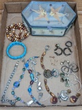 Costume jewelry earring and bracelets, plus a beveled glass trinket box that measures 7
