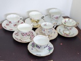Five English bone china tea cups and saucers, plus two other sets. All are in good condition.