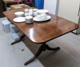 Located in basement, please bring help to remove. Duncan Phyfe drop leaf table is 5-1/2' x 3'
