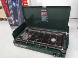 Coleman pressure regulated two burner propane stove appears in fair and usable condition. Features