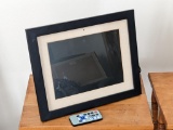 Polaroid digital picture frame with cord and remote. Turns on and display looks good. Measures about