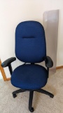 Sturdy rolling office chair and plastic floor mat are both in good condition.