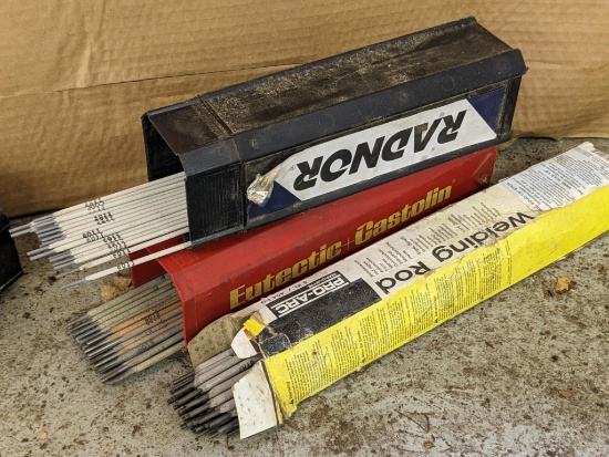 Three partial containers of welding rods incl. 6011, 7018, and 6013. Largest are 1/8".