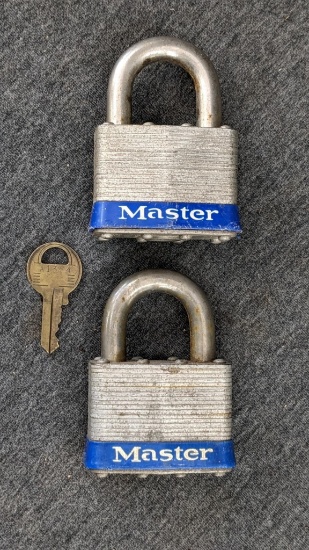 Pair of keyed alike Master Lock padlocks with key. About 3" long.
