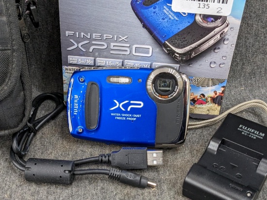 Fuji Film Finepix XP50 camera with box, charger, cord, and case. Camera is dust, freeze, shock, and