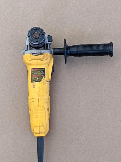 Dewalt angle grinder model D28110. Grinder has handle, is missing guard, but runs.