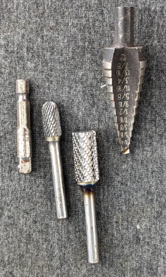 Two carbide burrs w/ 1/4" shanks, larger has 1/2" head, and an Irwin step drill.