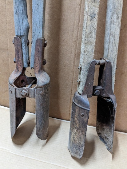 Two post hole diggers, larger one has very good scoops and edges, the smaller one has a couple dents