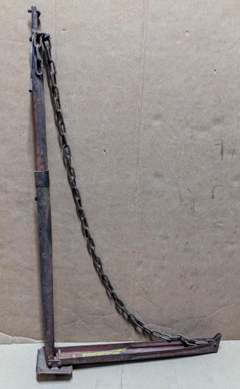 Vintage automotive jack is nearly 4' tall.