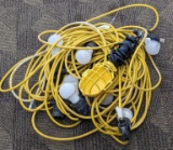 Temporary work light string and a smaller work light. Works and is about 85' long. Tag is marked