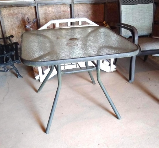 Glass top patio table and four chairs - all in good shape. Table is approx. 3' square.